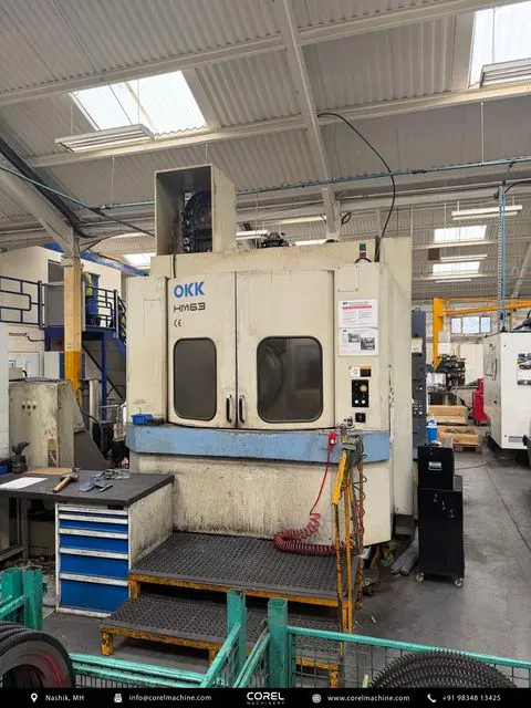 Used OKK HM-63 Horizontal Machining Centers (HMC) Pallet Changer for sale - Front overview showing enclosure